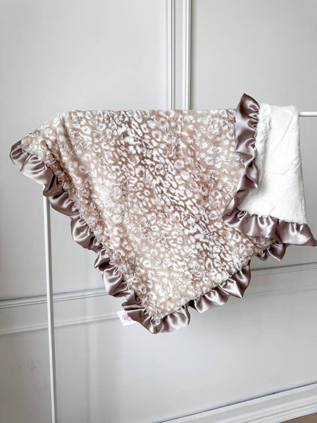 Decorative blanket with ruffled edges leopard print backed with white
